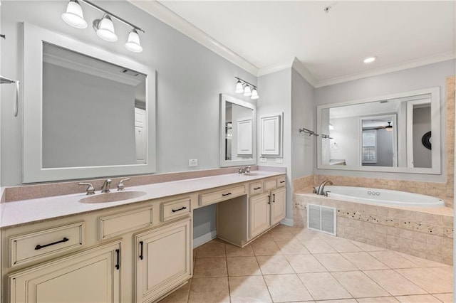 bathroom with tile patterned flooring, vanity, crown molding, and tiled bath