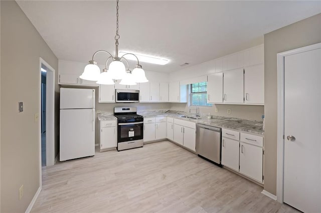5807 Christopher Ln, Lithonia, GA 30058 - kitchen featuring appliances with stainless steel finishes, a sink, a chandelier, white cabinetry, and light wood finished floors