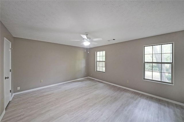 5807 Christopher Ln, Lithonia, GA 30058 - unfurnished room featuring light wood finished floors, a textured ceiling, baseboards, and ceiling fan