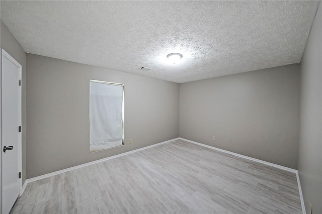 5807 Christopher Ln, Lithonia, GA 30058 - spare room with wood finished floors, a textured ceiling, and baseboards