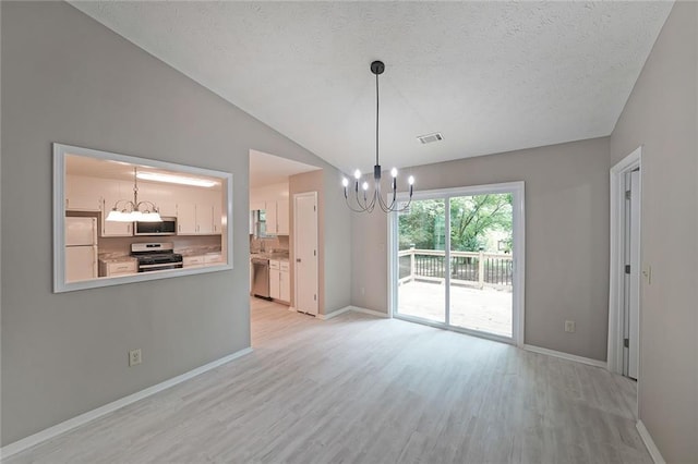 5807 Christopher Ln, Lithonia, GA 30058 - unfurnished dining area featuring a chandelier, light wood finished floors, baseboards, a textured ceiling, and lofted ceiling