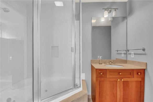 bathroom featuring vanity and a shower with shower door