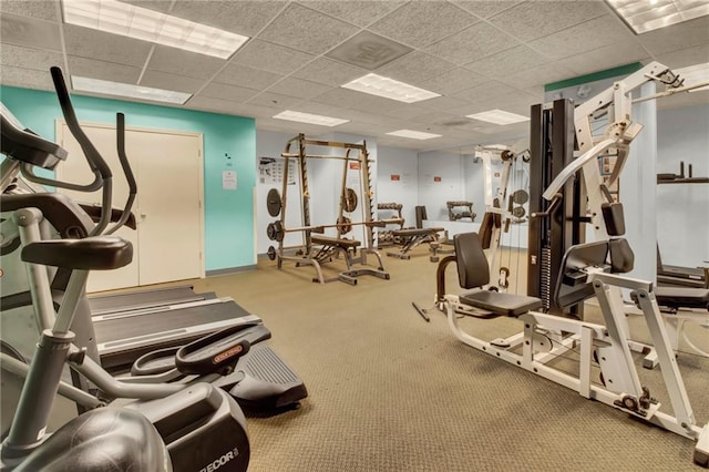 exercise room featuring carpet and a drop ceiling