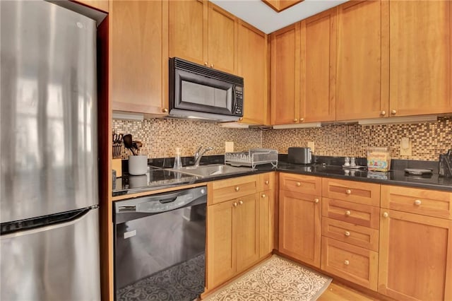 kitchen with decorative backsplash, sink, and black appliances