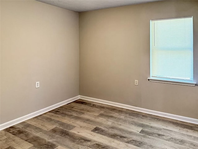 unfurnished room featuring hardwood / wood-style flooring