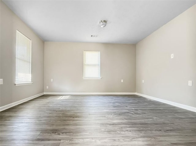 empty room with dark wood-type flooring