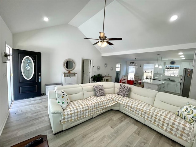 living area featuring recessed lighting, high vaulted ceiling, a ceiling fan, and light wood finished floors