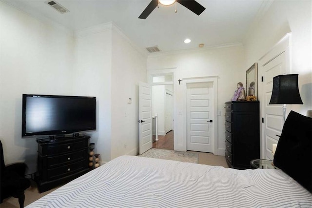 bedroom with ceiling fan and ornamental molding