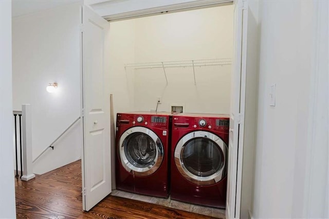 clothes washing area featuring dark hardwood / wood-style floors and independent washer and dryer