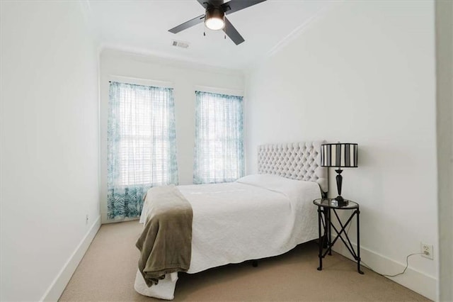 bedroom featuring light carpet, ceiling fan, and ornamental molding