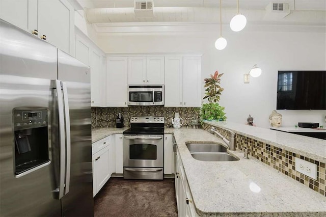 kitchen featuring stainless steel appliances, hanging light fixtures, white cabinets, light stone counters, and sink