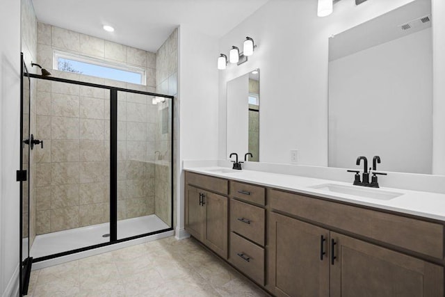 bathroom with vanity and a shower with shower door