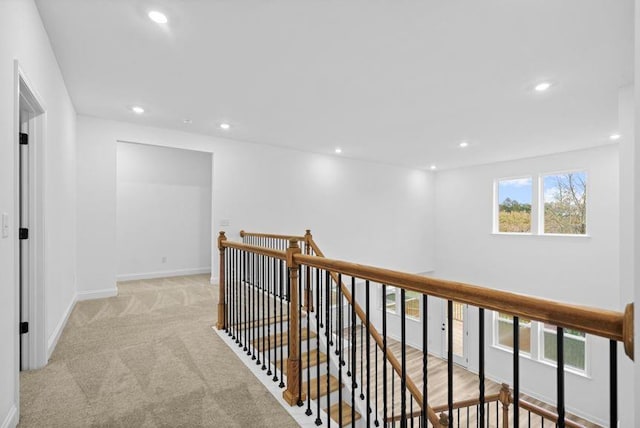 corridor featuring light colored carpet