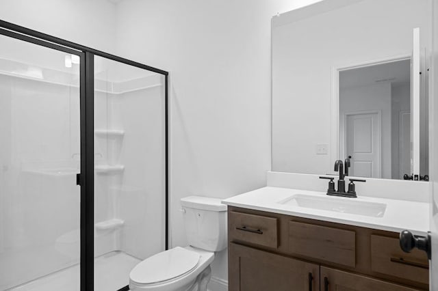 bathroom with vanity, toilet, and walk in shower