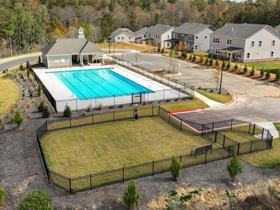 view of swimming pool featuring a lawn and a patio