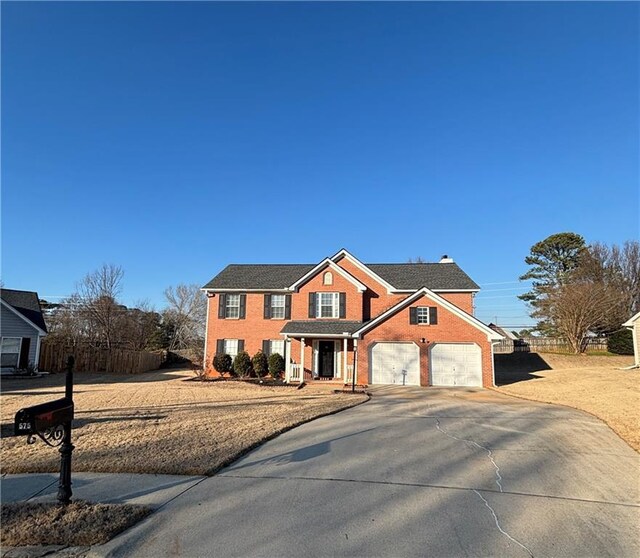 view of front of property featuring a garage and a front yard