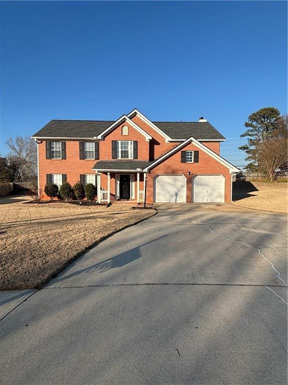 view of front facade featuring concrete driveway, brick siding, and a porch