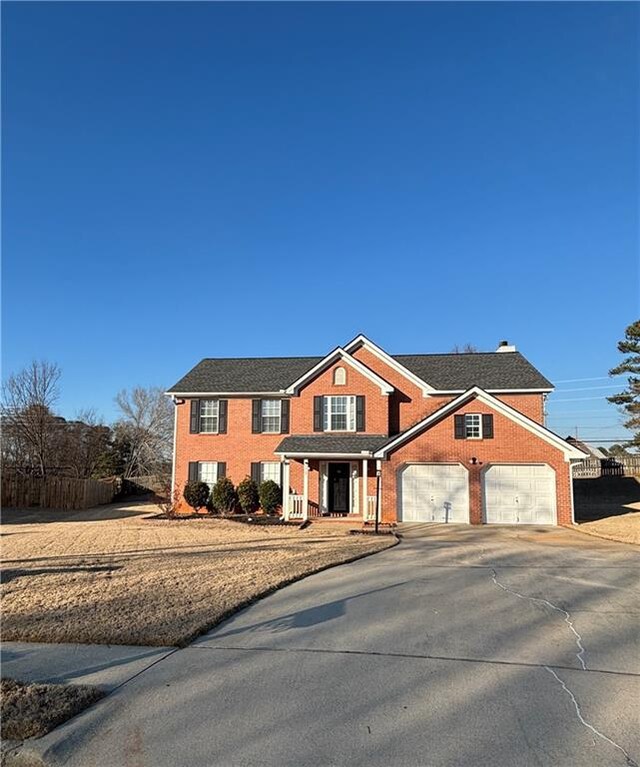 view of front of home with a garage and a front lawn