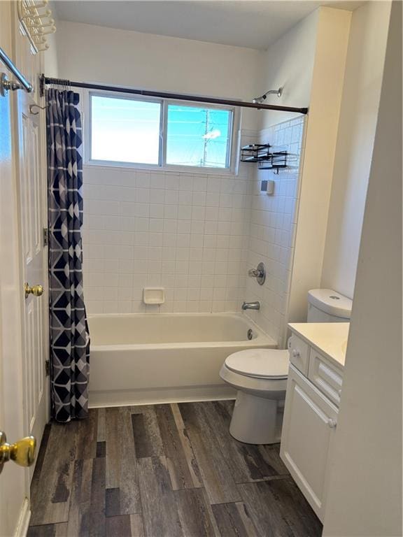 full bath featuring a healthy amount of sunlight, shower / tub combo, wood finished floors, and vanity