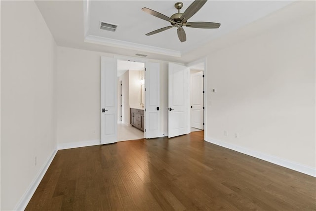 551 Pearl St, Cumming, GA 30040 - unfurnished bedroom with a raised ceiling, dark wood-style floors, ensuite bath, and ceiling fan