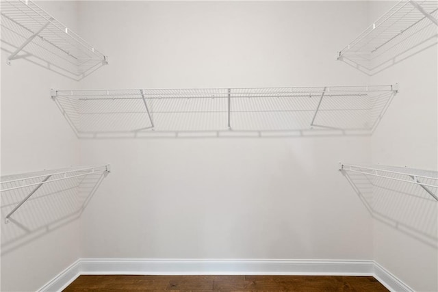 551 Pearl St, Cumming, GA 30040 - walk in closet with dark wood-style flooring