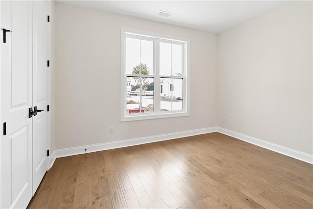 551 Pearl St, Cumming, GA 30040 - unfurnished bedroom with wood finished floors and a closet