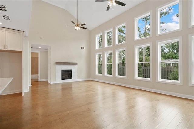 551 Pearl St, Cumming, GA 30040 - unfurnished living room with high vaulted ceiling, a ceiling fan, light wood-style flooring, and a fireplace