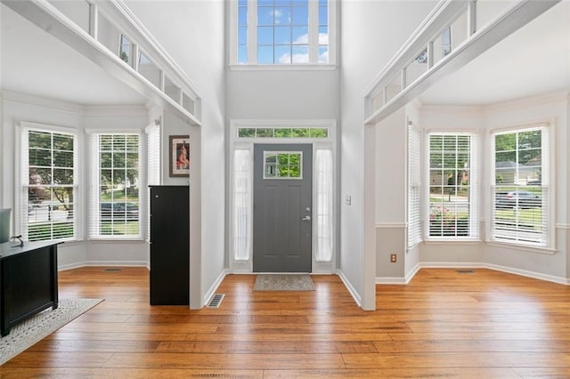 1126 Gate Post Ct, Powder Springs, GA 30127 - unfurnished dining area with baseboards, an inviting chandelier, a healthy amount of sunlight, and hardwood / wood-style flooring