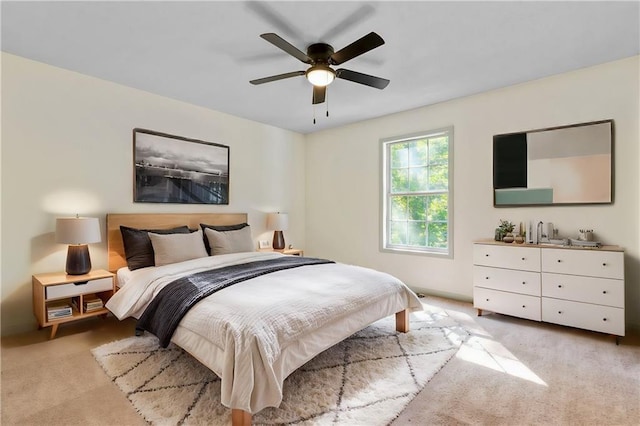 bedroom with light carpet and ceiling fan