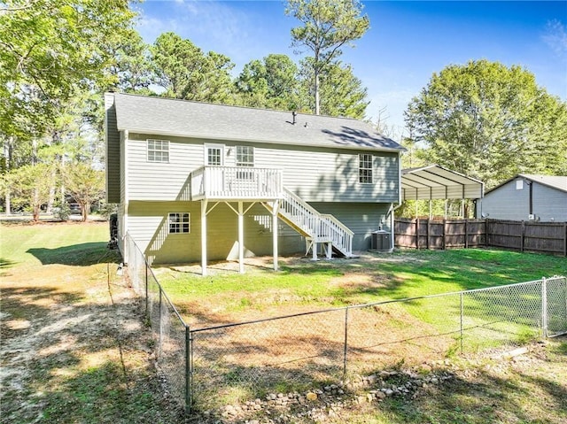 rear view of property featuring central AC unit, a carport, a wooden deck, and a lawn