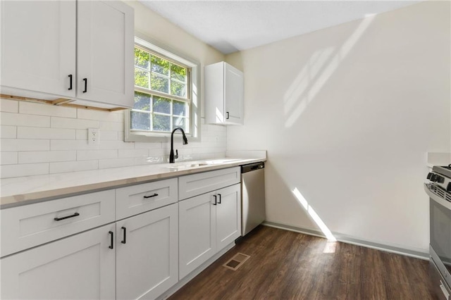 kitchen with white cabinetry, dark wood-type flooring, light stone counters, and appliances with stainless steel finishes