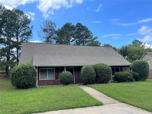 2613 Shore Wood Ct NE, Conyers, GA 30013 - view of front facade with a front yard, brick siding, and a shingled roof