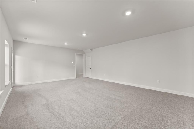 carpeted empty room with baseboards and recessed lighting