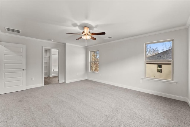 spare room with carpet, visible vents, and baseboards