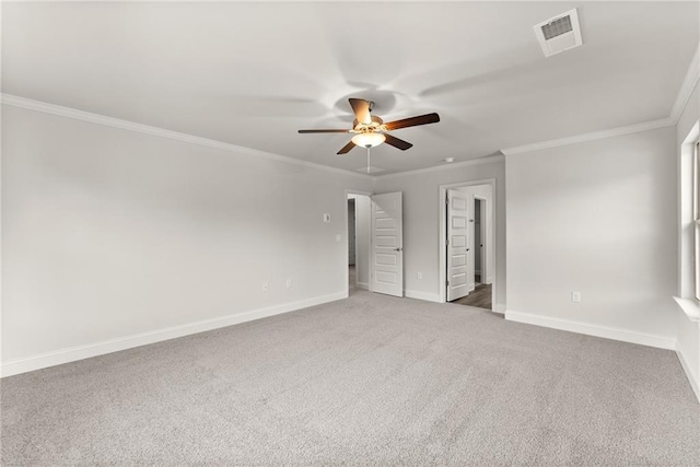 unfurnished bedroom featuring baseboards, carpet floors, visible vents, and crown molding