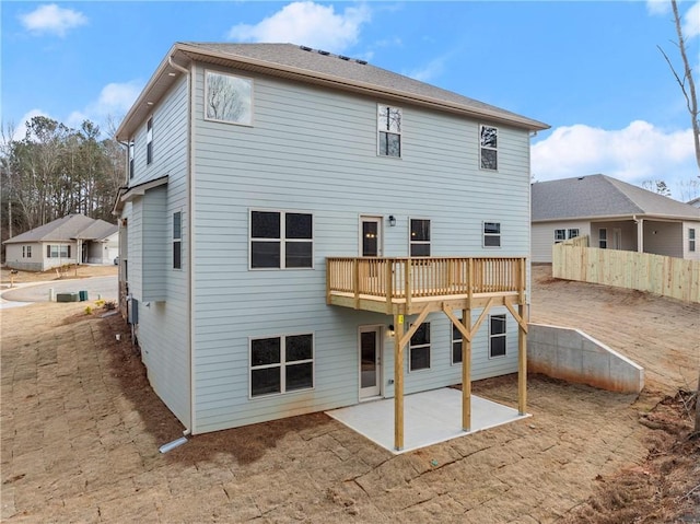rear view of house featuring fence and a patio