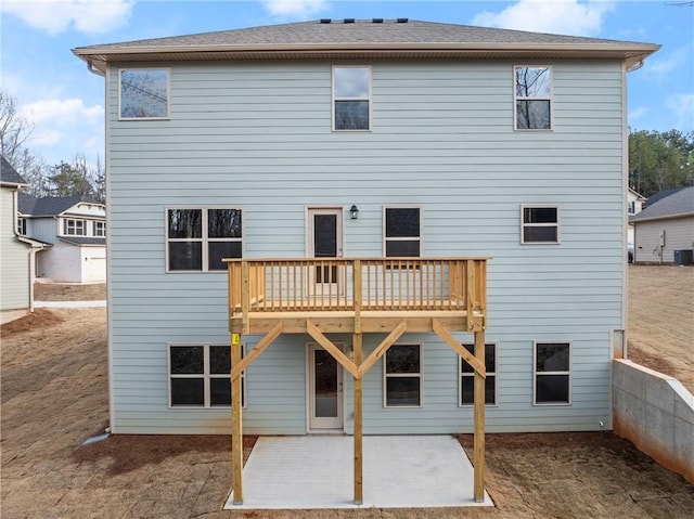 rear view of house with a wooden deck, central AC, and a patio