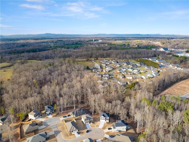 birds eye view of property featuring a wooded view