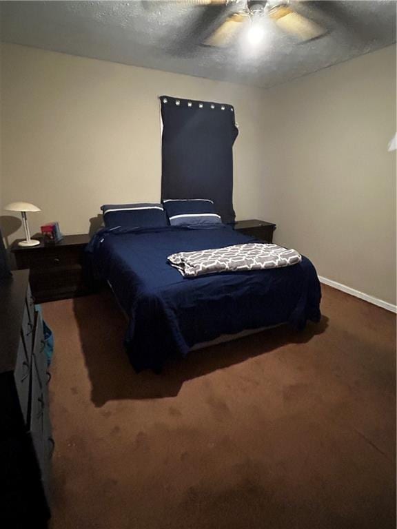 carpeted bedroom featuring a textured ceiling and ceiling fan