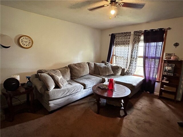 carpeted living room with ceiling fan and a textured ceiling