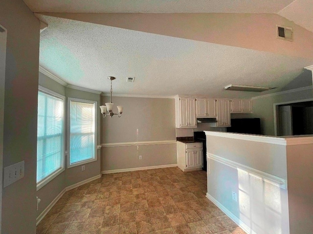 kitchen featuring an inviting chandelier, a wealth of natural light, white cabinetry, and decorative light fixtures