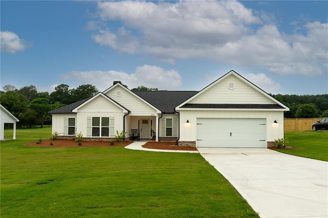 201 Advent Dr, Winder, GA 30680 - single story home with board and batten siding, an attached garage, a front yard, driveway, and a shingled roof