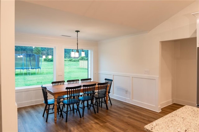201 Advent Dr, Winder, GA 30680 - dining space featuring dark wood-type flooring, a wainscoted wall, ornamental molding, and a decorative wall