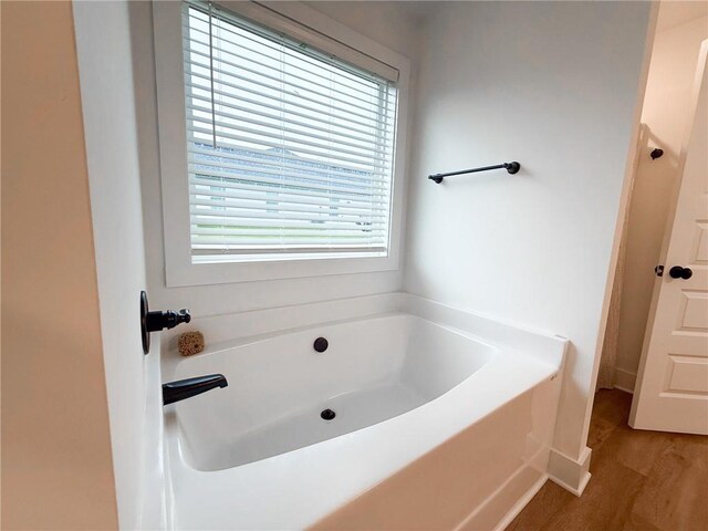 201 Advent Dr, Winder, GA 30680 - full bathroom featuring a bath and wood finished floors