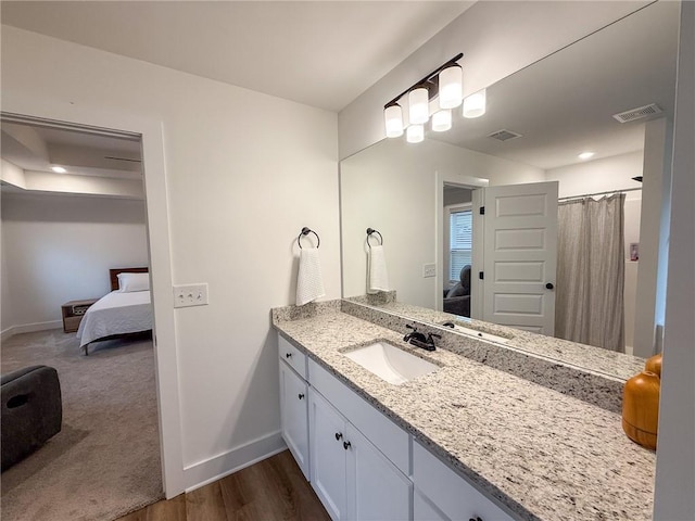 201 Advent Dr, Winder, GA 30680 - ensuite bathroom with baseboards, vanity, and wood finished floors