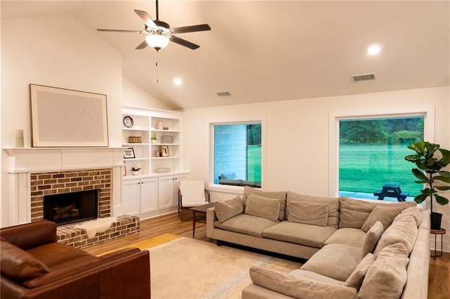 201 Advent Dr, Winder, GA 30680 - living area featuring wood finished floors, ceiling fan, lofted ceiling, and a fireplace