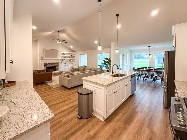 201 Advent Dr, Winder, GA 30680 - kitchen with appliances with stainless steel finishes, a ceiling fan, vaulted ceiling, a sink, and light wood-style floors