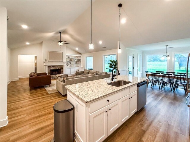 201 Advent Dr, Winder, GA 30680 - kitchen featuring a sink, dishwasher, a ceiling fan, light wood finished floors, and vaulted ceiling