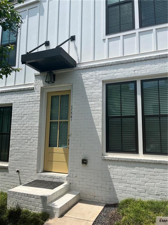 exterior space with brick siding and board and batten siding