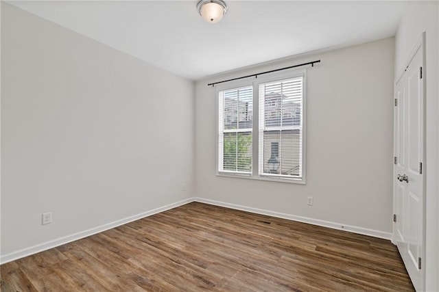 1227 Cushenberry Ln, Atlanta, GA 30318 - unfurnished bedroom featuring wood finished floors and baseboards